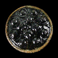 Black glass inset with raised dots on the front.